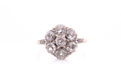 Lot 68 - A platinum and diamond daisy cluster ring, set...