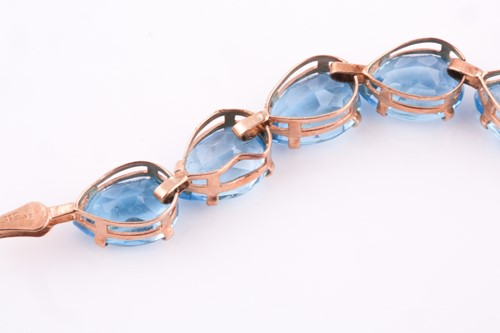 Lot 229 - A 9ct yellow gold and blue topaz bracelet, set...