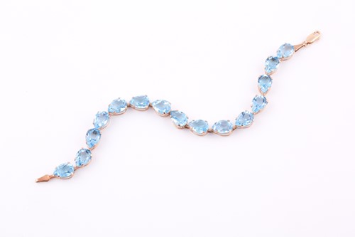 Lot 229 - A 9ct yellow gold and blue topaz bracelet, set...