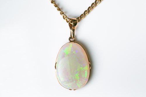 Lot 226 - A yellow metal mounted opal pendant, the...