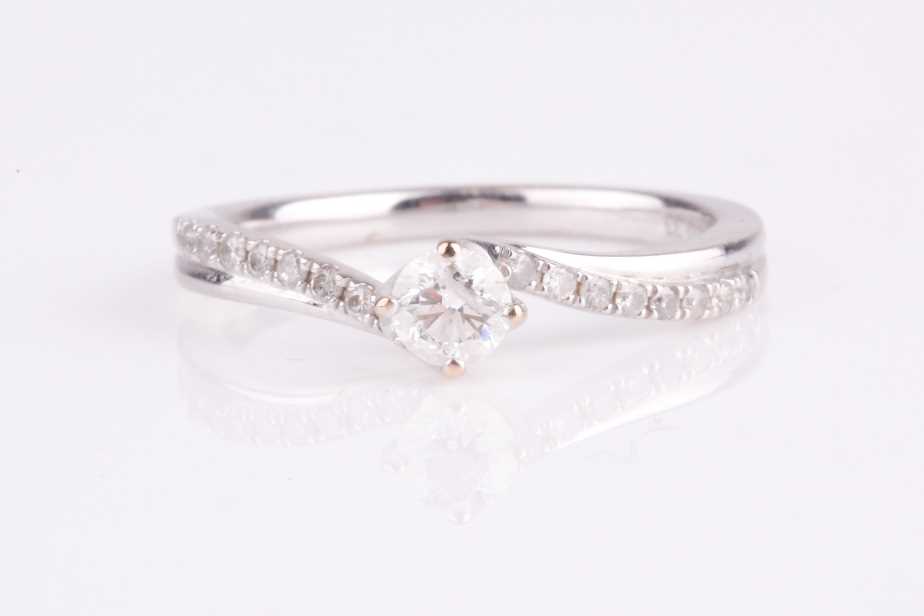 Lot 138 - An 18ct white gold and diamond engagement ring,...