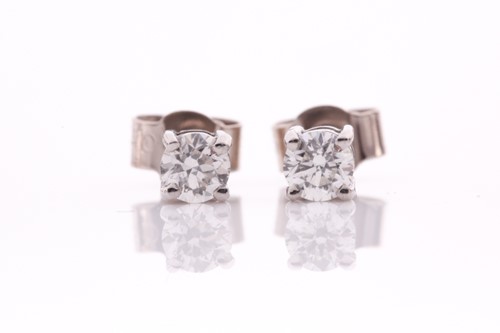 Lot 97 - A pair of 18ct white gold and solitaire...
