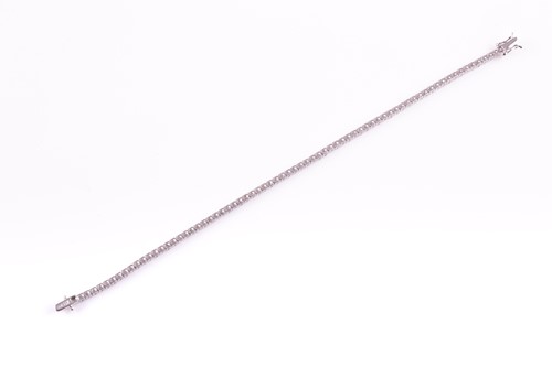 Lot 120 - An 18ct white gold and diamond line bracelet,...