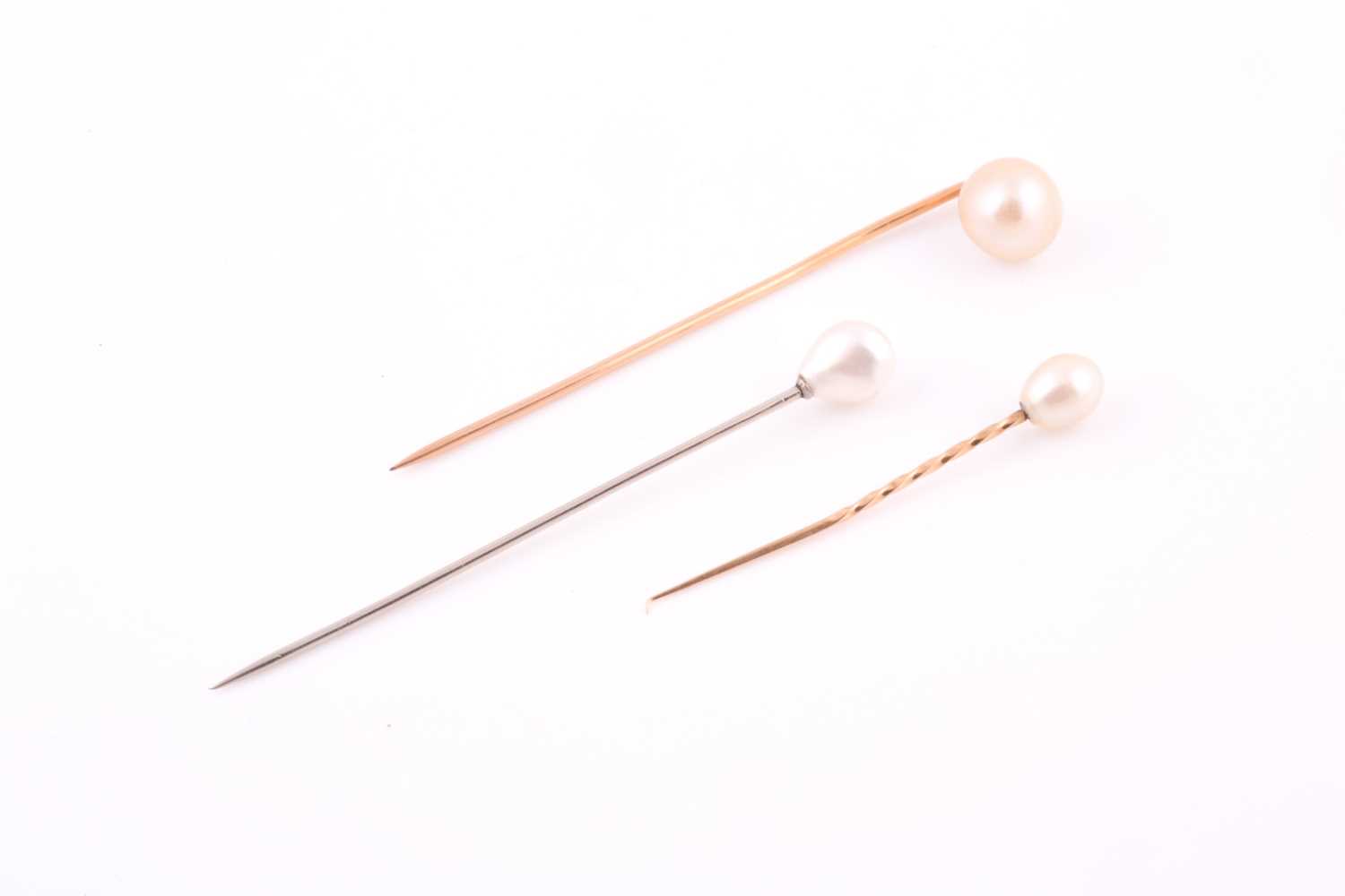 Lot 139 - A white metal and natural pearl tie pin, set...
