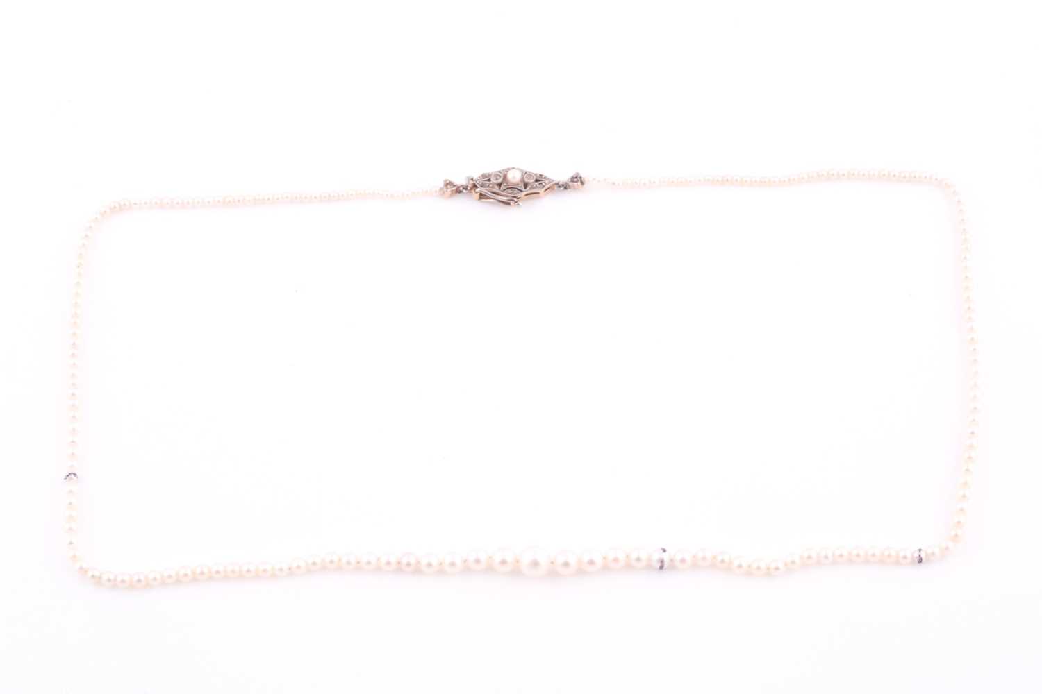 Lot 255 - A single strand natural pearl necklace, the...
