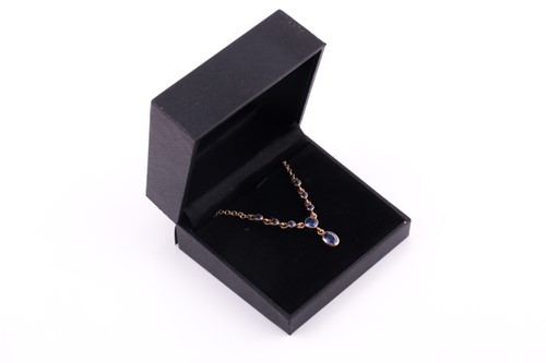 Lot 36 - A 9ct yellow gold and blue sapphire drop...