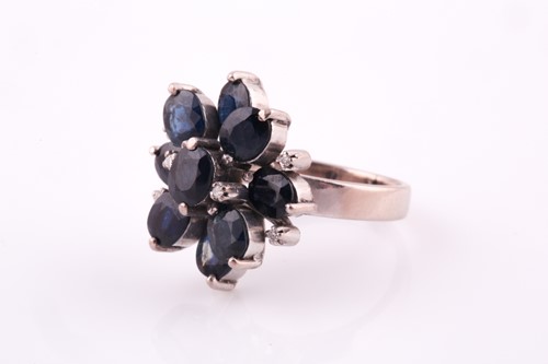 Lot 47 - A 1970's sapphire and diamond cluster ring,...
