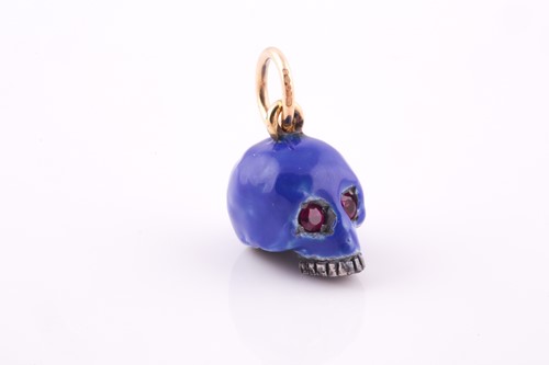Lot 112 - An unusual enamel and ruby skull pendant, the...