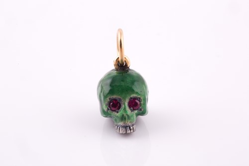 Lot 240 - A silver and green enamel skull pendant,...
