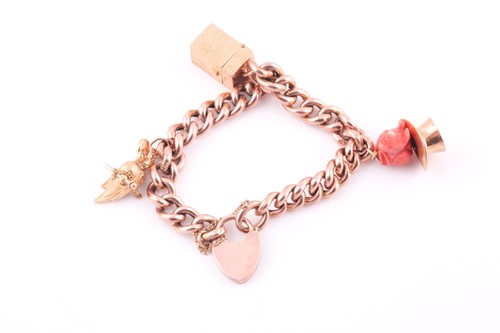 Lot 18 - A 9ct rose gold curb-lik charm bracelet, with...