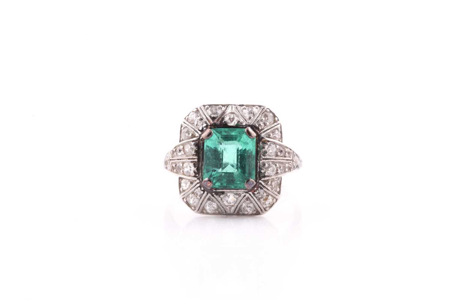 Lot 13 - An emerald and diamond dress ring, set with an...