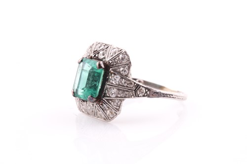 Lot 13 - An emerald and diamond dress ring, set with an...