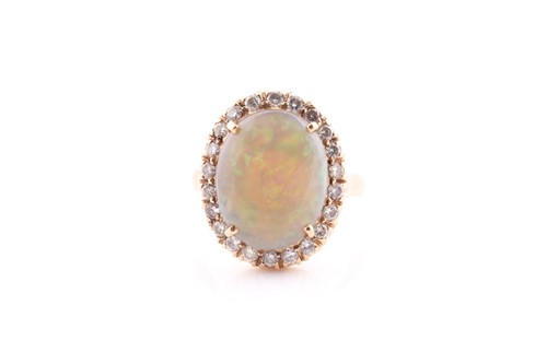 Lot 311 - An opal and diamond cluster ring, the opal...