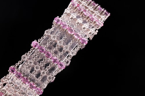 Lot 184 - An 18ct white gold, diamond, and pink sapphire...