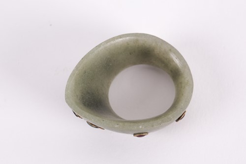 Lot 139 - An Indian moss green jade archer's ring yellow...