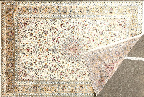 Lot 177 - An ivory ground Kashan carpet of classical...