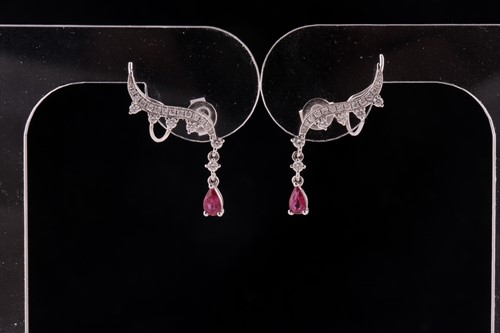 Lot 64 - A pair of ruby and diamond earrings; styled as...