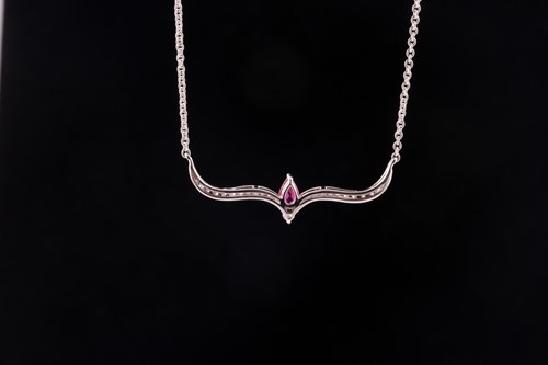 Lot 178 - A ruby and diamond necklace; the fixed scroll...