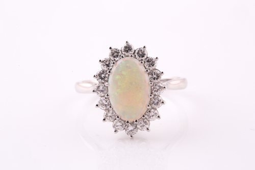 Lot 225 - An opal and diamond cluster ring; the...