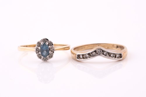 Lot 475 - A diamond and blue topaz oval cluster ring in...