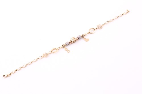 Lot 7 - A charm bracelet; the oval link chain strung...