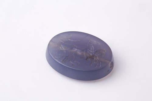 Lot 498 - A Roman-style carved amethyst glass oval...