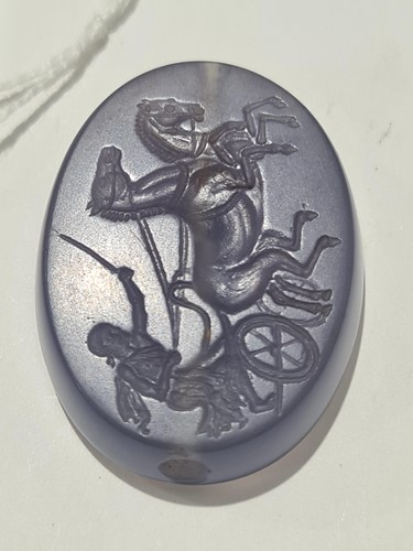 Lot 498 - A Roman-style carved amethyst glass oval...