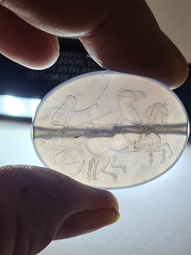 Lot 498 - A Roman-style carved amethyst glass oval...