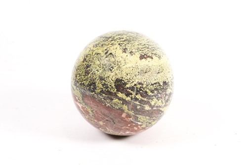 Lot 325 - A green and red striated marble sphere, 27cm dia