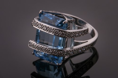 Lot 352 - A white metal, diamond, and blue topaz ring,...