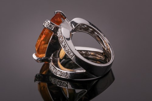 Lot 53 - A diamond and citrine cocktail ring, set with...