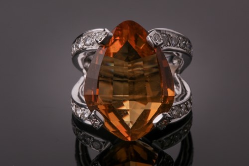 Lot 53 - A diamond and citrine cocktail ring, set with...