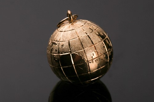 Lot 369 - A yellow metal globe pendant, with engraved...