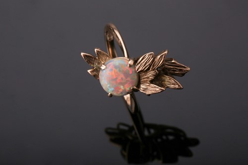 Lot 266 - A 9ct yellow gold and opal ring, set with a...