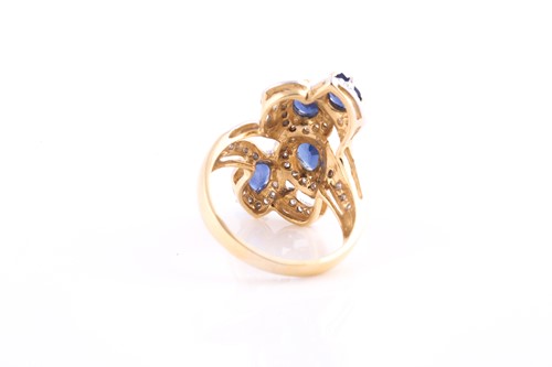 Lot 399 - An 18ct yellow gold, diamond, and blue...