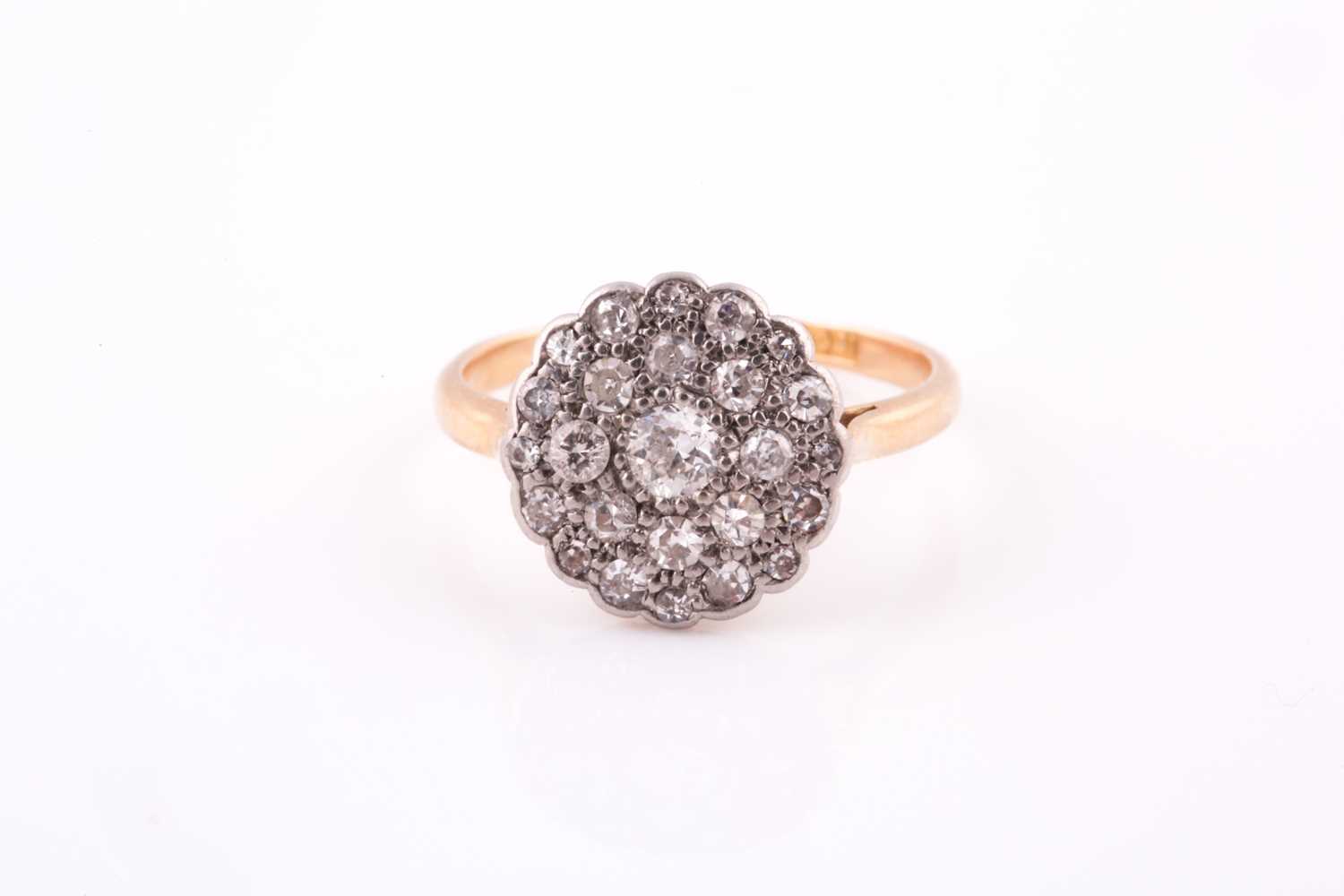 Lot 203 - An 18ct yellow gold and diamond cluster ring,...