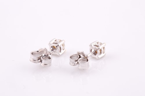 Lot 298 - A pair of solitaire diamond stud earrings, the...