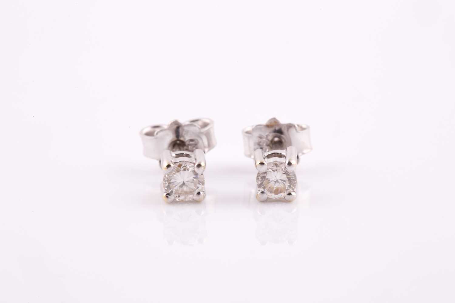 Lot 298 - A pair of solitaire diamond stud earrings, the...