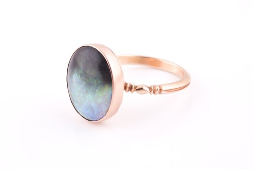 Lot 81 - A yellow metal and boulder opal ring, the...