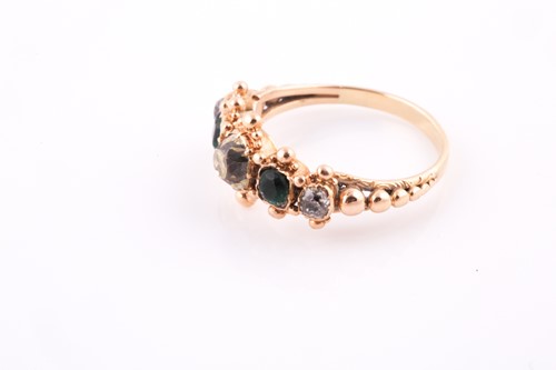 Lot 296 - A yellow metal, diamond, and emerald ring, set...