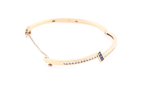 Lot 162 - A 14ct yellow gold, diamond, and sapphire...