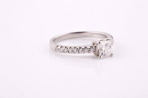 Lot 317 - A princess cut diamond ring, claw set in...
