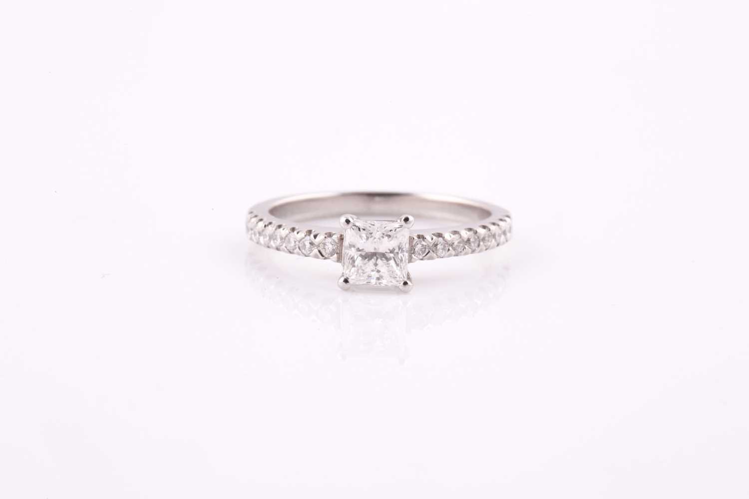Lot 317 - A princess cut diamond ring, claw set in...
