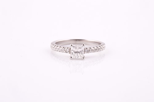 Lot 317 - A princess cut diamond ring, claw set in...
