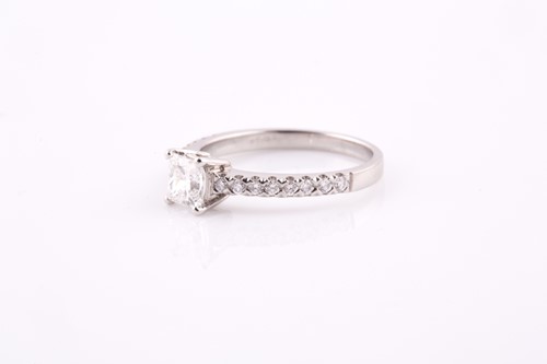 Lot 317 - A princess cut diamond ring, claw set in...