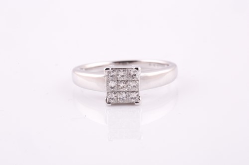 Lot 573 - An 18ct white gold diamond dress ring,...