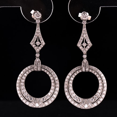 Lot 124 - A pair of diamond drop earrings, each with...