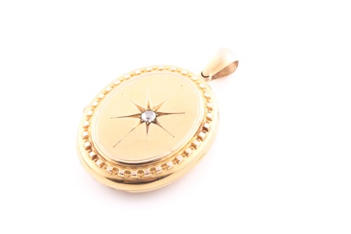 Lot 66 - A Victorian yellow metal oval-shaped locket...