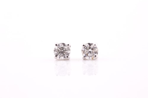 Lot 373 - A pair of solitaire diamond earrings, set with...