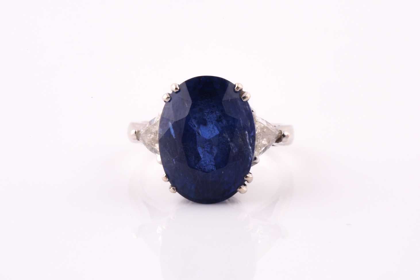 Lot 411 - A sapphire and diamond three stone ring, the...